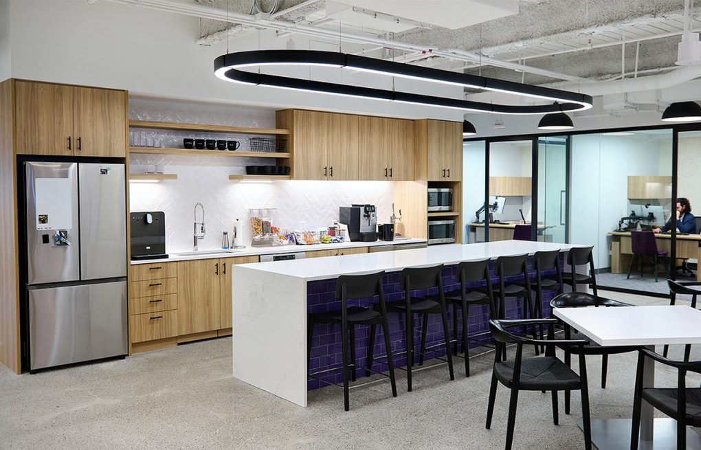 A wide angle shot of the kitchen and break area of a modern and open office.
