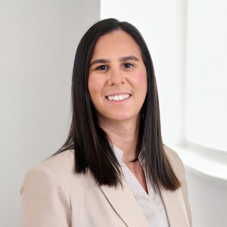 A member of the Easy Mile Fitness leadership team smiles at the camera in a professional headshot.
