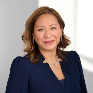 A member of the Easy Mile Fitness leadership team smiles at the camera in a professional headshot.