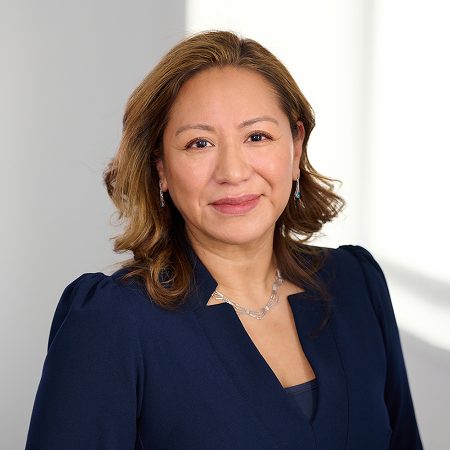 A member of the Easy Mile Fitness leadership team smiles at the camera in a professional headshot.