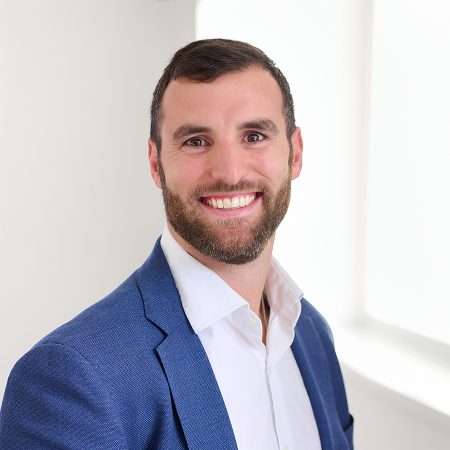 A member of the Easy Mile Fitness leadership team smiles at the camera in a professional headshot.